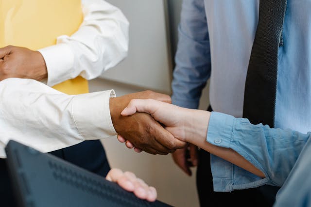 a close up of two people shaking hands