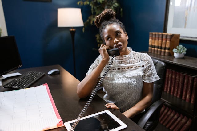 a property manager taking a call at their desk