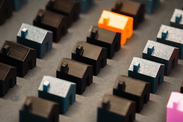 a bunch of house figurines in black, blue, and orange