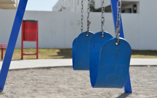 blue swing set at a playground