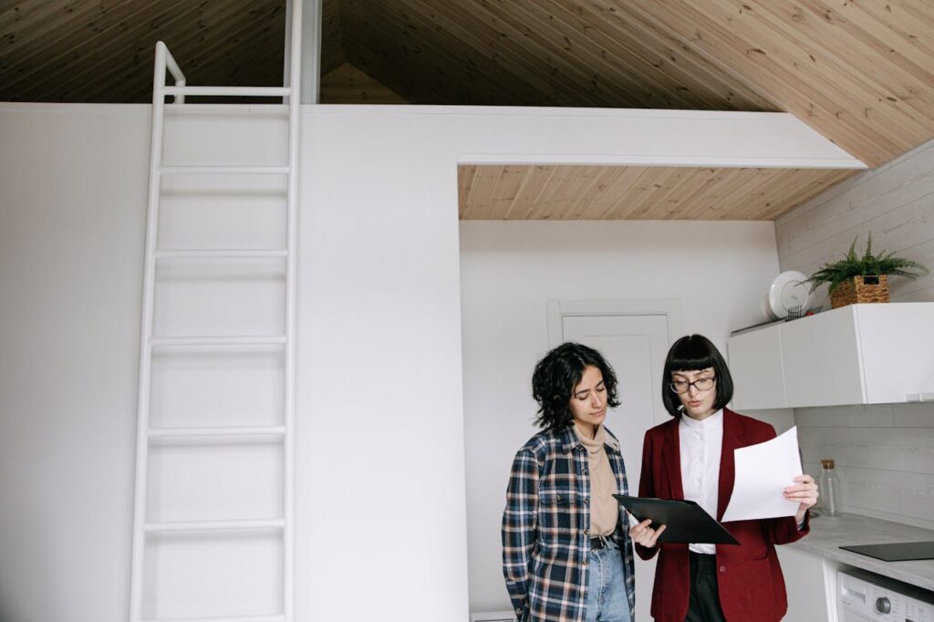 two people inside house looking at a clipboard